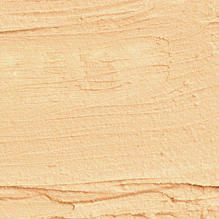 Application du Fond de teint stick 772 Beige doré sur la peau